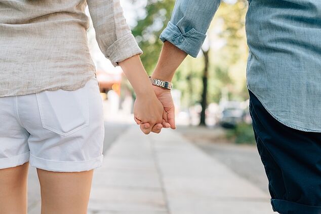 A man without potential problems holds a woman's hand